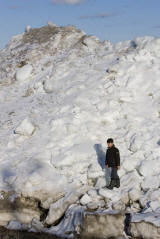 Boy near bottom of shoreline ice in Moosonee, Ontario