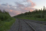 looking along tracks to old Moosonee water tower at sunset
